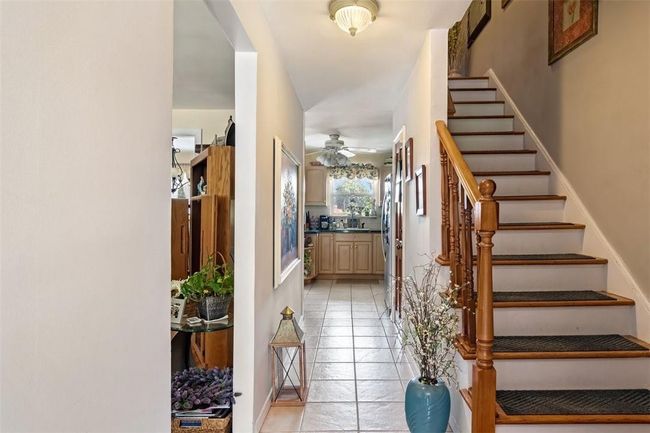 Tiled foyer featuring ceiling fan and sink | Image 9
