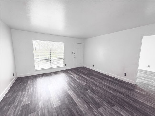 Unfurnished room featuring dark hardwood / wood-style floors | Image 8