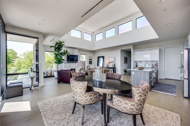 Dining room with light wood-style flooring, a large fireplace, and recessed lighting | Image 16