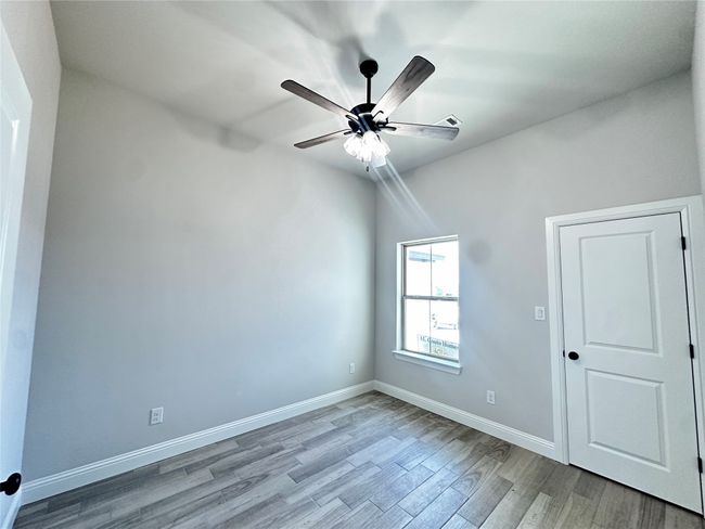 Spare room featuring wood finished floors, a ceiling fan, and baseboards | Image 21
