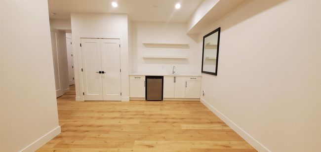 Bar featuring wet bar, a sink, baseboards, light wood-style floors, and recessed lighting | Image 5