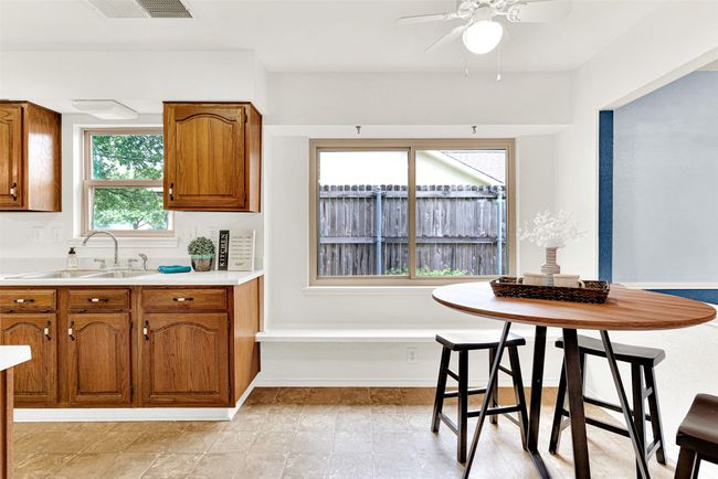 Kitchen featuring brown cabinets, ceiling fan, and light countertops | Image 27