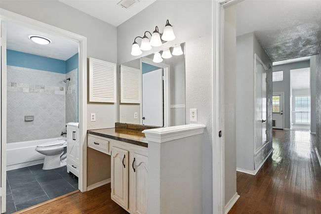 Full bath featuring vanity, tub / shower combination, and hardwood / wood-style floors | Image 15