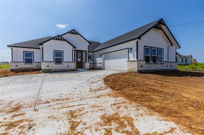 Modern farmhouse style home with a garage | Image 1