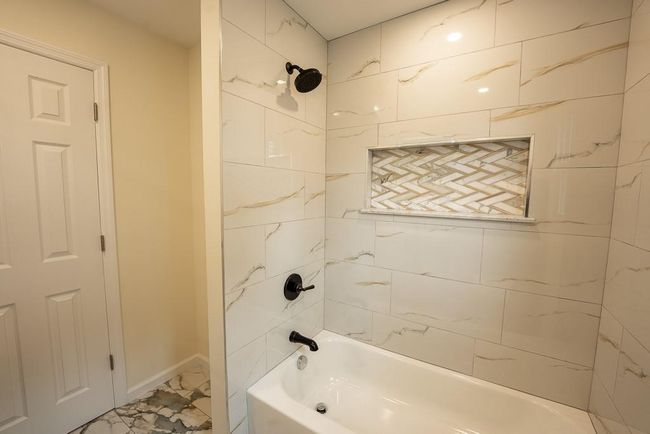 Full bathroom featuring marble finish floor, baseboards, and washtub / shower combination | Image 20