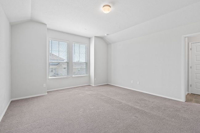 Unfurnished room with vaulted ceiling and carpet floors | Image 19