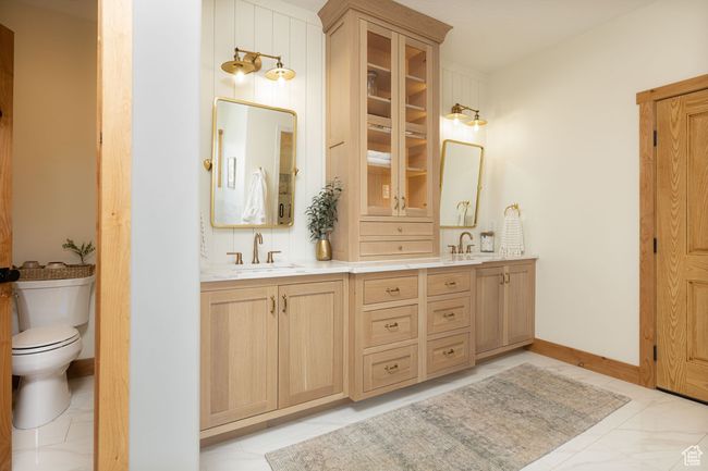 Bathroom featuring double vanity, a sink, and toilet | Image 23