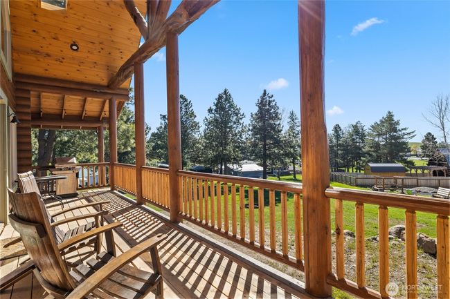 The back porch, an extension of the wraparound porch, where you will find mountain views for days. Take in a leisurely afternoon soaking up the sun while you plan the yard projects, family gatherings and fun times to come. | Image 5