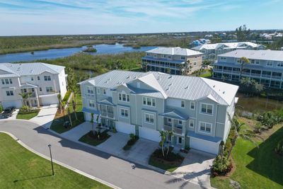 This residence overlooks a pond in the rear and the upper level captures some views overlooking Coral Creek. | Image 1