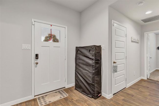 Front door, garage and one of the secondary bedrooms | Image 11