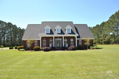 New england style home with a front yard | Image 1