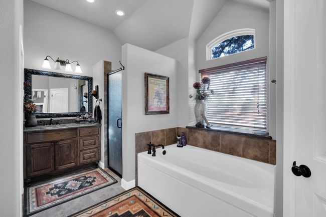 Bathroom with plus walk in shower, tile patterned floors, vaulted ceiling, and vanity | Image 17