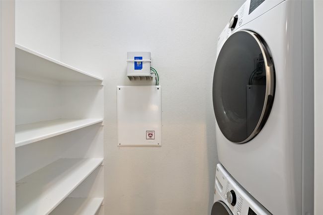 Laundry area with laundry area and stacked washer / drying machine | Image 11