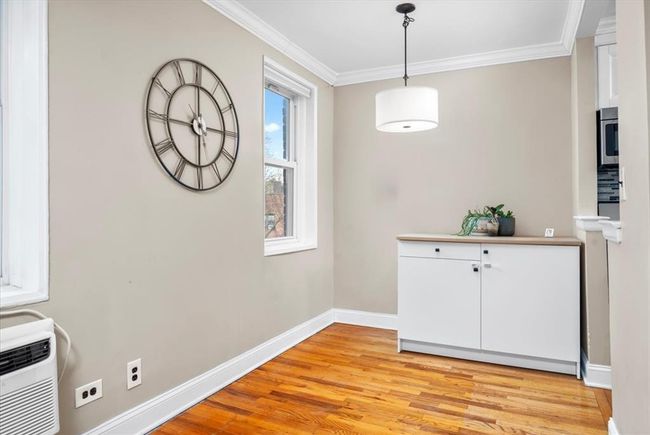 Unfurnished dining area with ornamental molding and light wood finished floors | Image 9