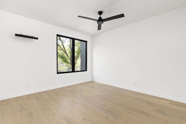 Empty room featuring light wood-style floors and a ceiling fan | Image 26