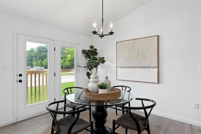 Dining space featuring hardwood / wood-style flooring, lofted ceiling, and a notable chandelier | Image 20
