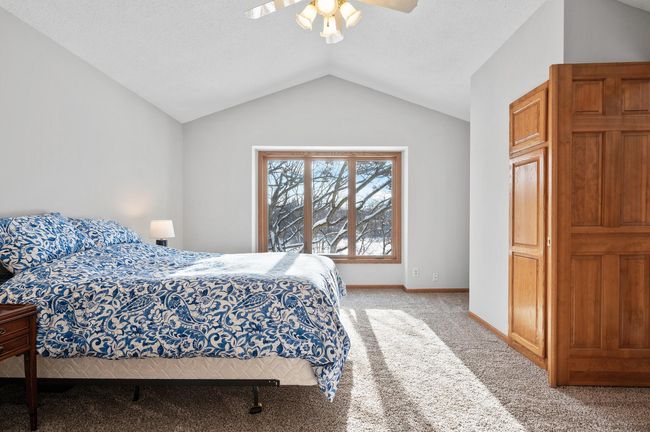 Wake up each morning with a view of the lake! The exceptional owner's suite features fresh paint, new carpet, a vaulted ceiling, and a private en suite bathroom. | Image 18