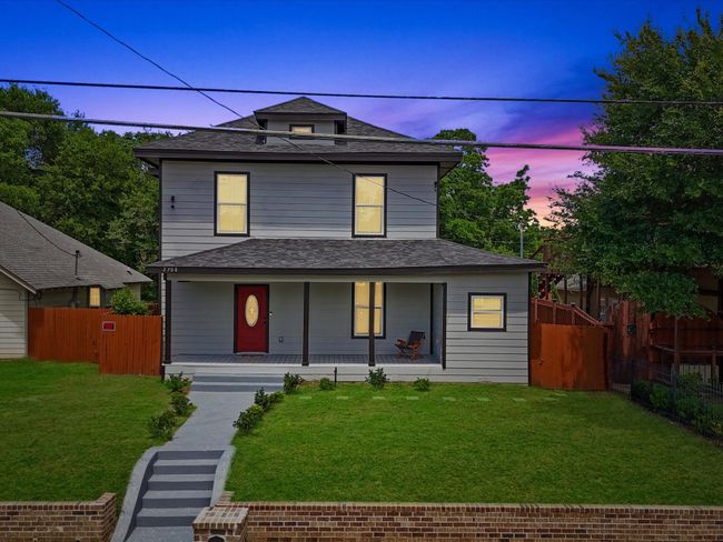 American foursquare style home with a shingled roof and covered porch | Image 4