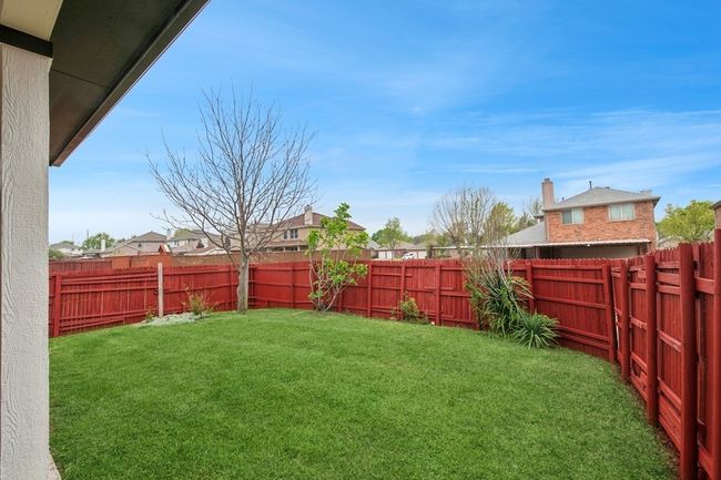 View of yard with a fenced backyard | Image 5