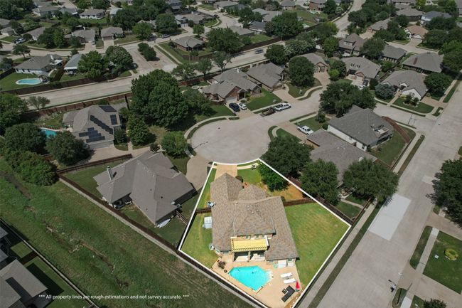 Aerial view of property's location with property parcel outlined, nearby suburban area, and a pool area | Image 36
