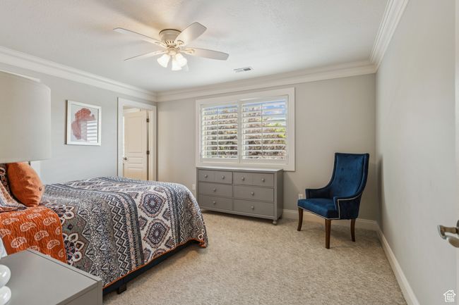 Bedroom featuring carpet flooring, crown molding, and ceiling fan | Image 48