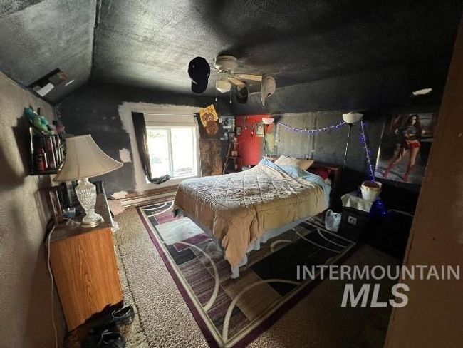 Bedroom featuring vaulted ceiling, carpet floors, and a textured ceiling | Image 5