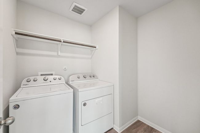 Laundry room featuring washer and dryer, wood finished floors, and baseboards | Image 19