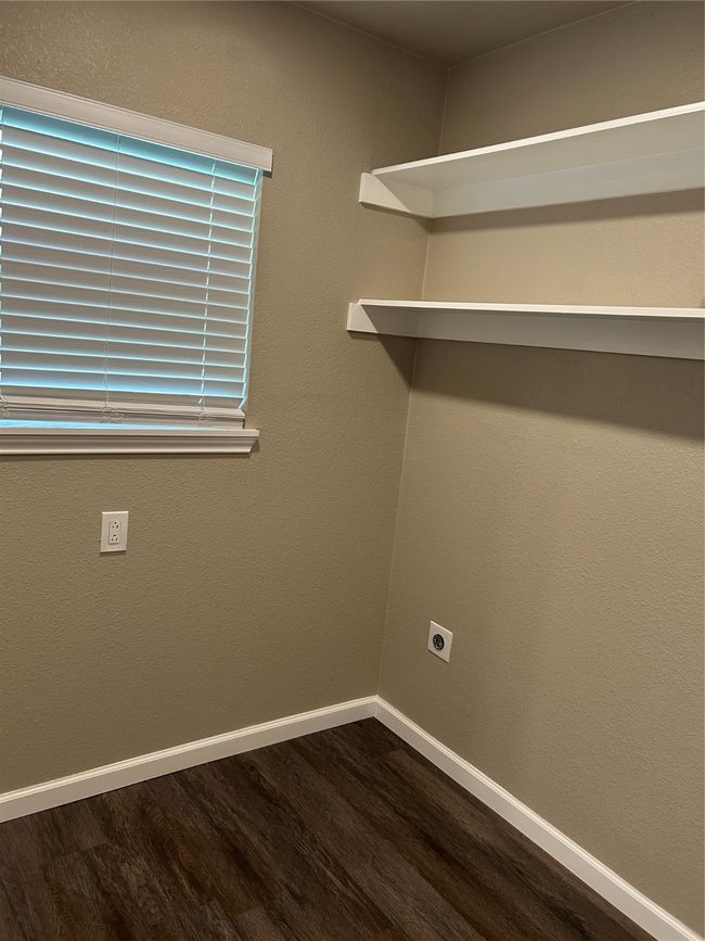Laundry room with dark wood-style flooring, electric dryer hookup, and baseboards | Image 8