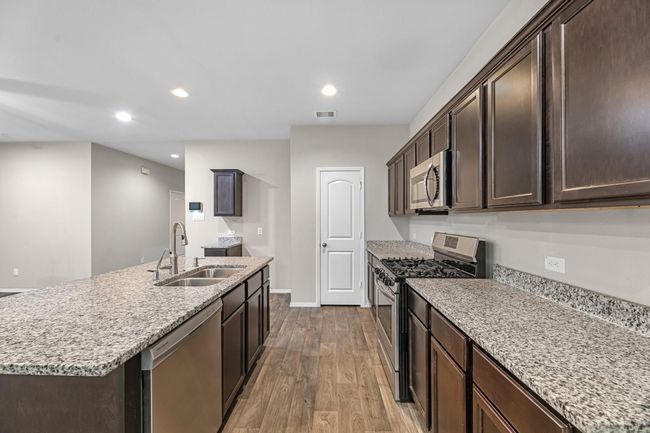 Handsome dark cabinets that offer so much storage. | Image 15