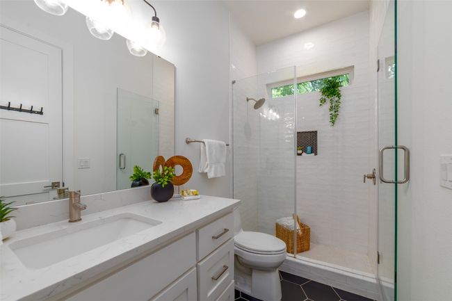 Bathroom featuring vanity, a stall shower, and tile patterned floors | Image 17