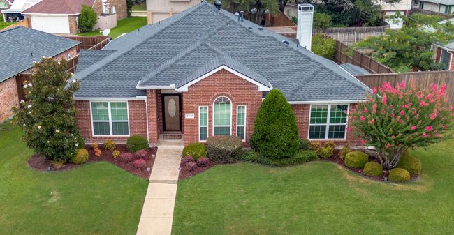 View of front of house with a shingled roof and brick siding | Image 29
