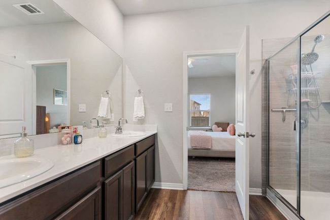 Primary bathroom with double vanity and walk-in shower. | Image 13