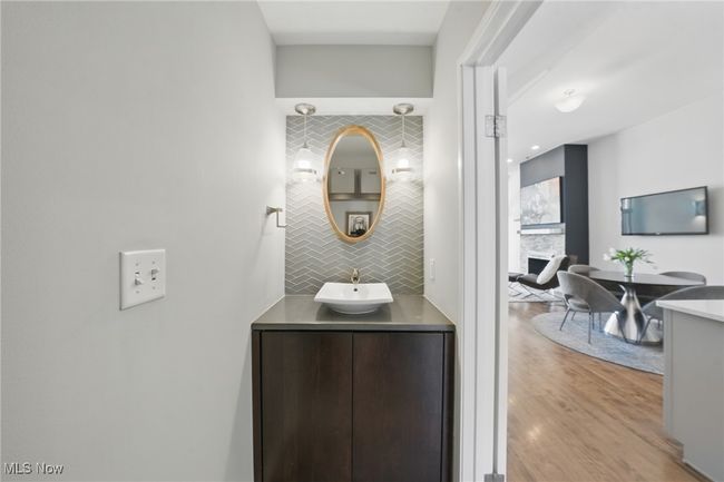 Bathroom featuring backsplash, wood finished floors, and vanity | Image 18