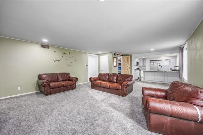 Carpeted living area with visible vents, recessed lighting, and baseboards | Image 29
