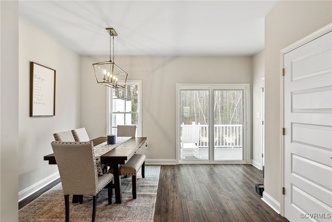 Dining room featuring dark wood-type flooring and an inviting chandelier | Image 4