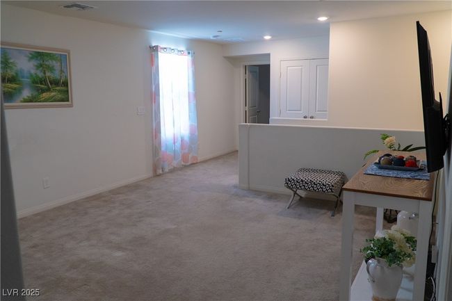 Sitting room featuring light carpet, baseboards, visible vents, and recessed lighting | Image 47