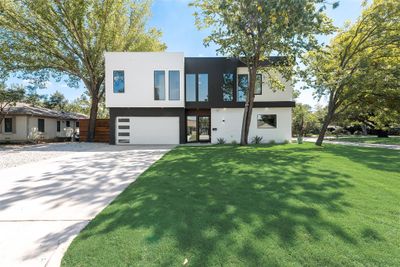 Modern home with a large front yard and a garage | Image 2