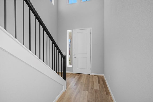 Entrance foyer with a towering ceiling, light wood-type flooring, and stairway | Image 4