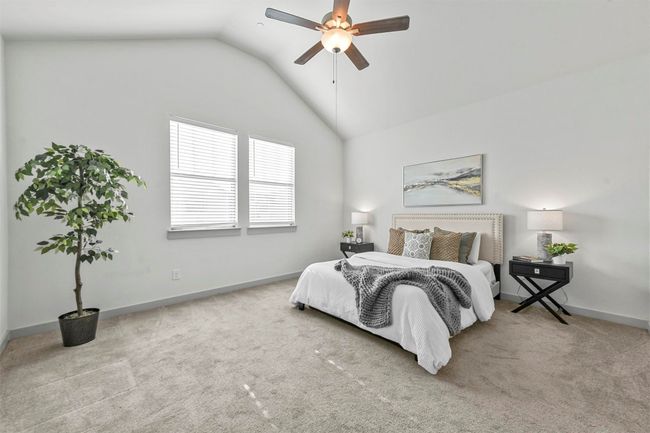 Carpeted bedroom featuring ceiling fan and lofted ceiling | Image 21