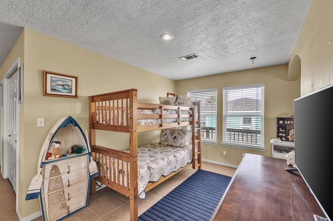 This open area is located near the entry to the primary sleeping area and offers lots of additional sleeping space. | Image 16