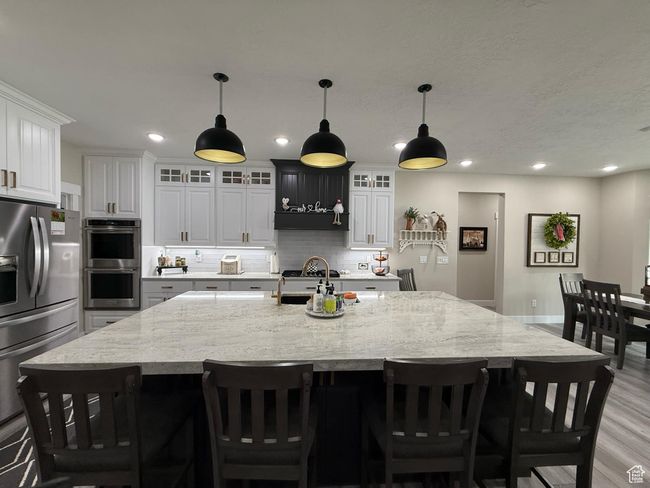 Kitchen with recessed lighting, stainless steel appliances, backsplash, and light wood-type flooring | Image 25