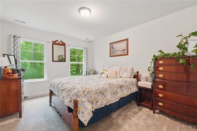 Comfortable upstairs bedroom with natural light and closet storage. | Image 23