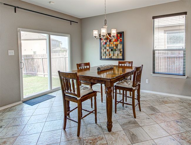 Dining area featuring a chandelier, a wealth of natural light, and baseboards | Image 8