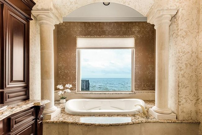 primary bath with soaking tub and views of the bay from the tup | Image 28