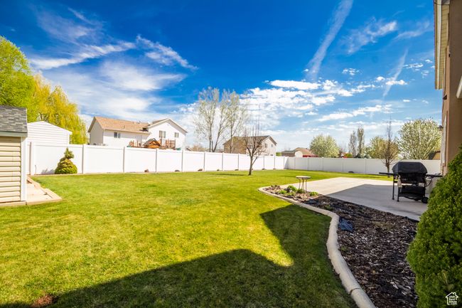 View of yard with a patio area, a residential view, and a fenced backyard | Image 32