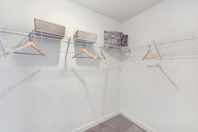 (Photo of decorated model, actual home's finishes may vary slightly) The owner's suite features an incredible walk-in closet. | Image 11