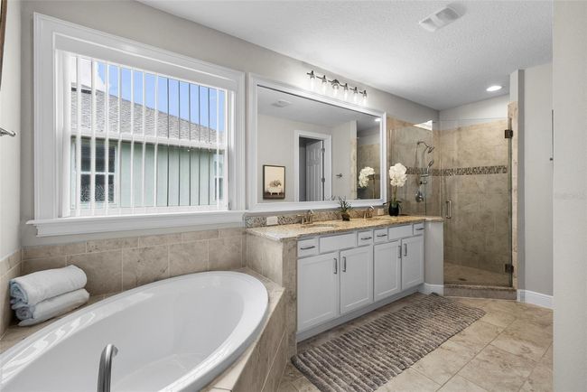 Spa-like bath with glass shower plus soaking tub | Image 35