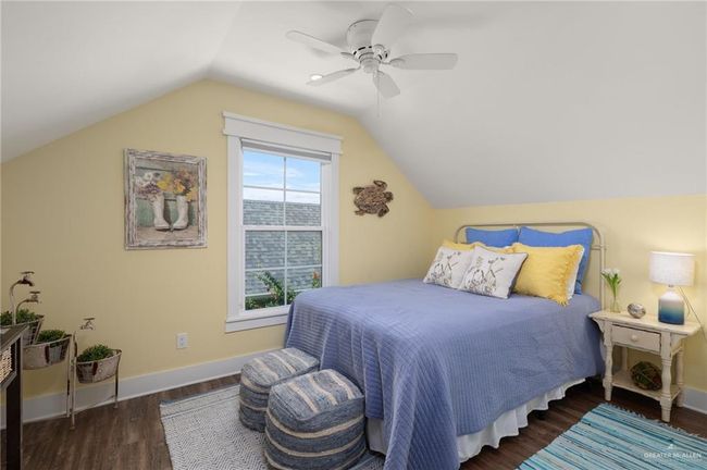 Bedroom with dark hardwood / wood-style floors, ceiling fan, and vaulted ceiling | Image 13