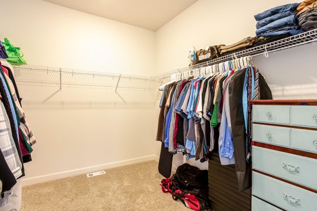 Expansive walk-in closet with built-in shelving and abundant hanging space to keep everything organized. | Image 23
