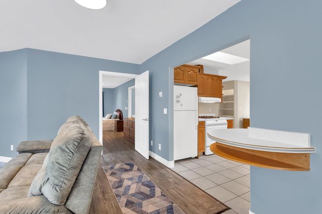 Interior space featuring freestanding refrigerator, baseboards, and light wood-type flooring | Image 4